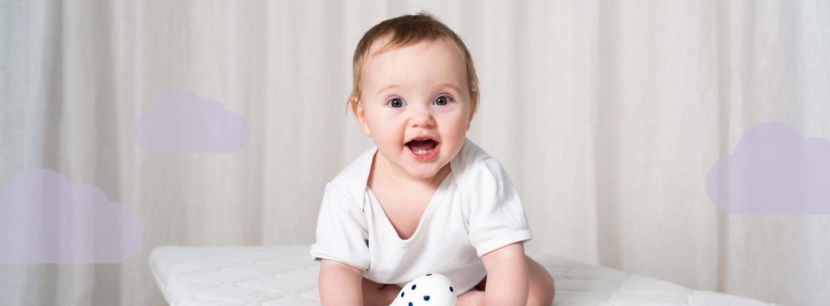 Träumeland Gift Certificate Baby on a mattress wearing a onesie with a cloud overlay